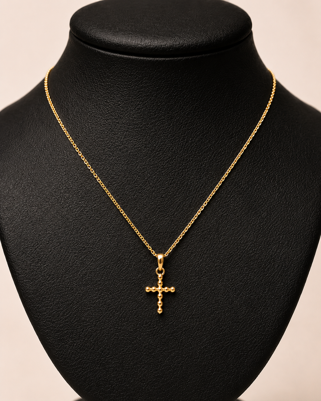 Gold necklace with ball cross charm